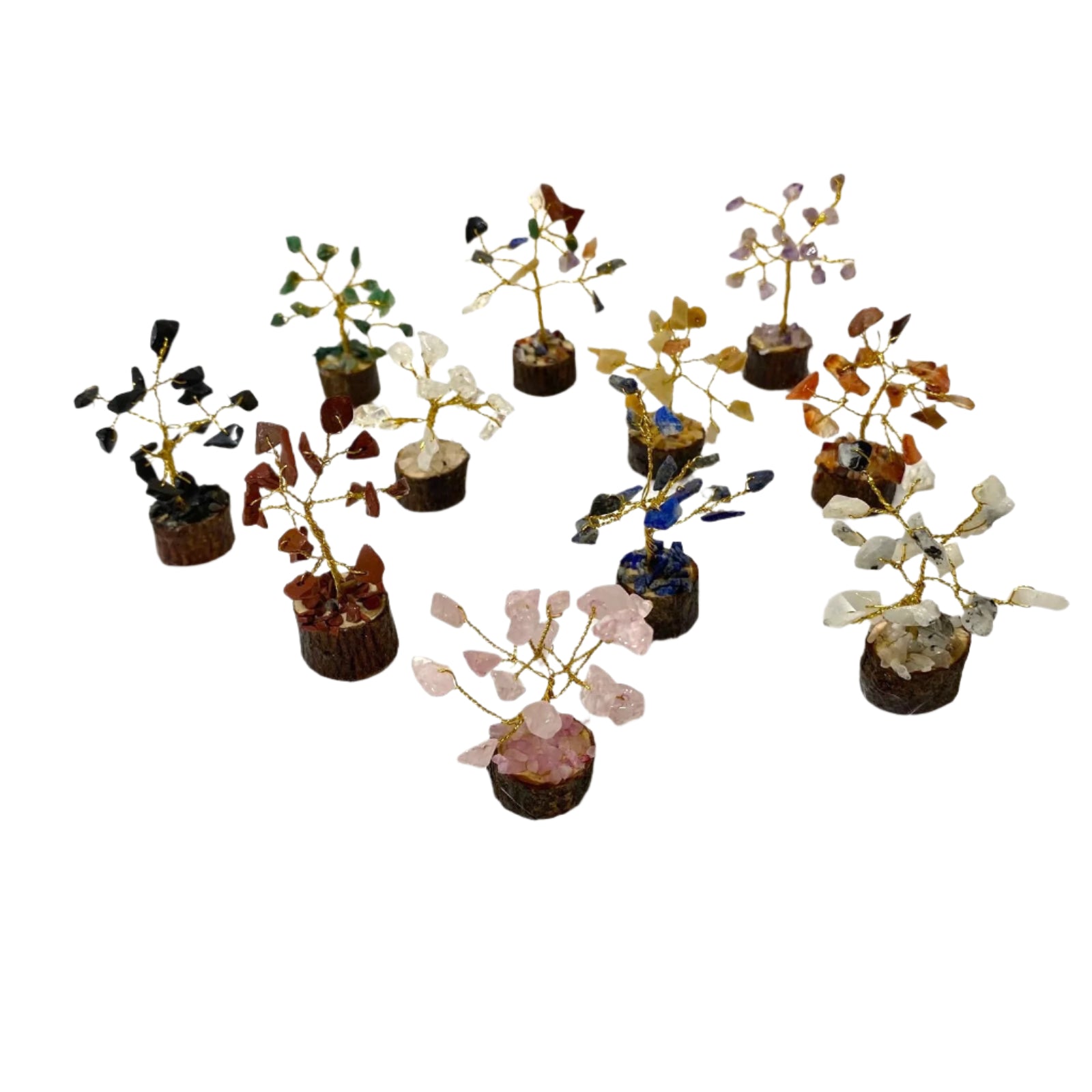 Collection of small decorative trees with crystals on a textured white surface