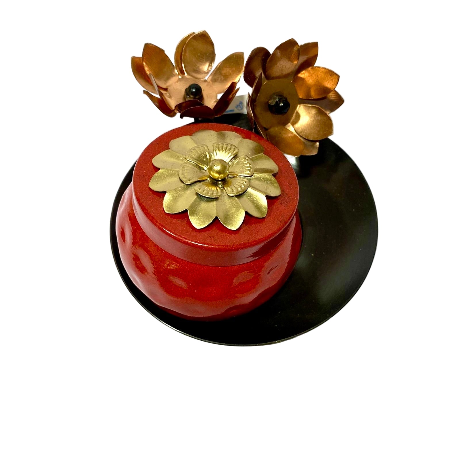 Decorative red container with gold floral designs on a white background