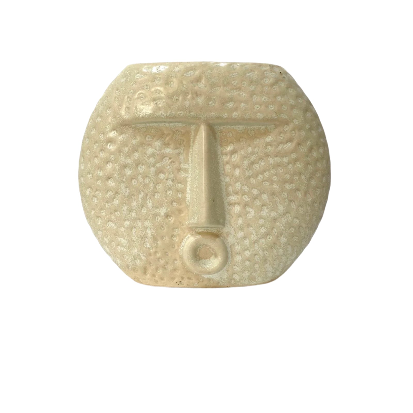 Ceramic face sculpture on a white surface with a light background