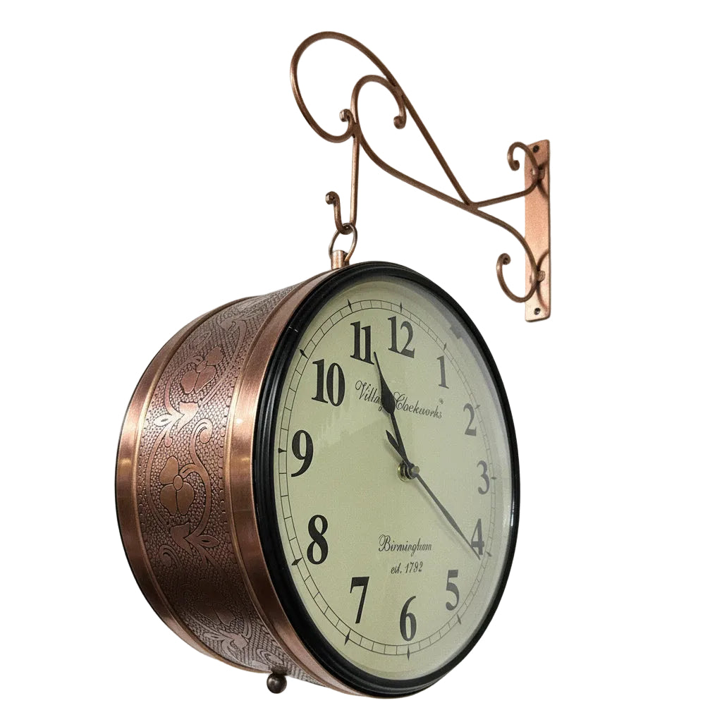 Decorative wall clock with copper finish on a plain background