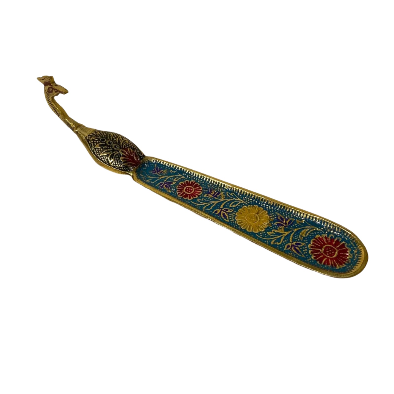 Decorative metal object with floral patterns on a textured white background
