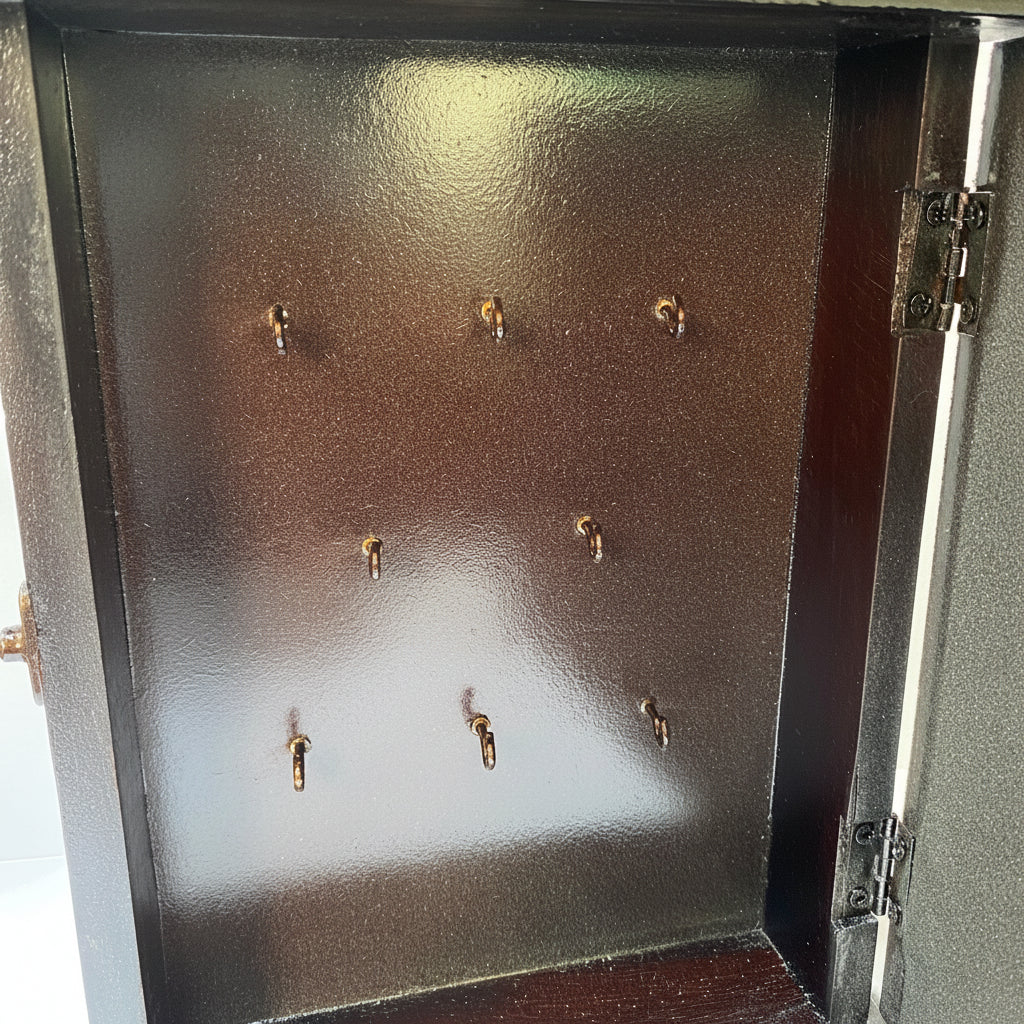 Metallic jewelry display case with earring hooks on a white background