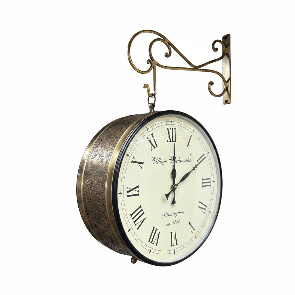 Vintage-style wall clock with brass finish hanging on a wall in an indoor setting.