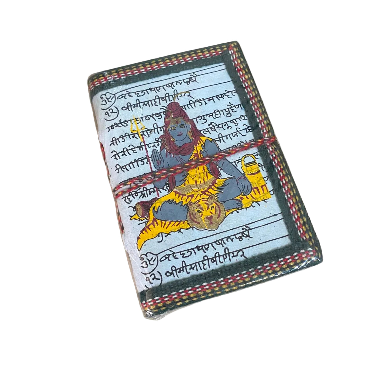 A small handmade notebook or journal with a colorful illustrated cover featuring a blue-skinned figure and a yellow tiger, bound with a red string, placed on a light wood surface.