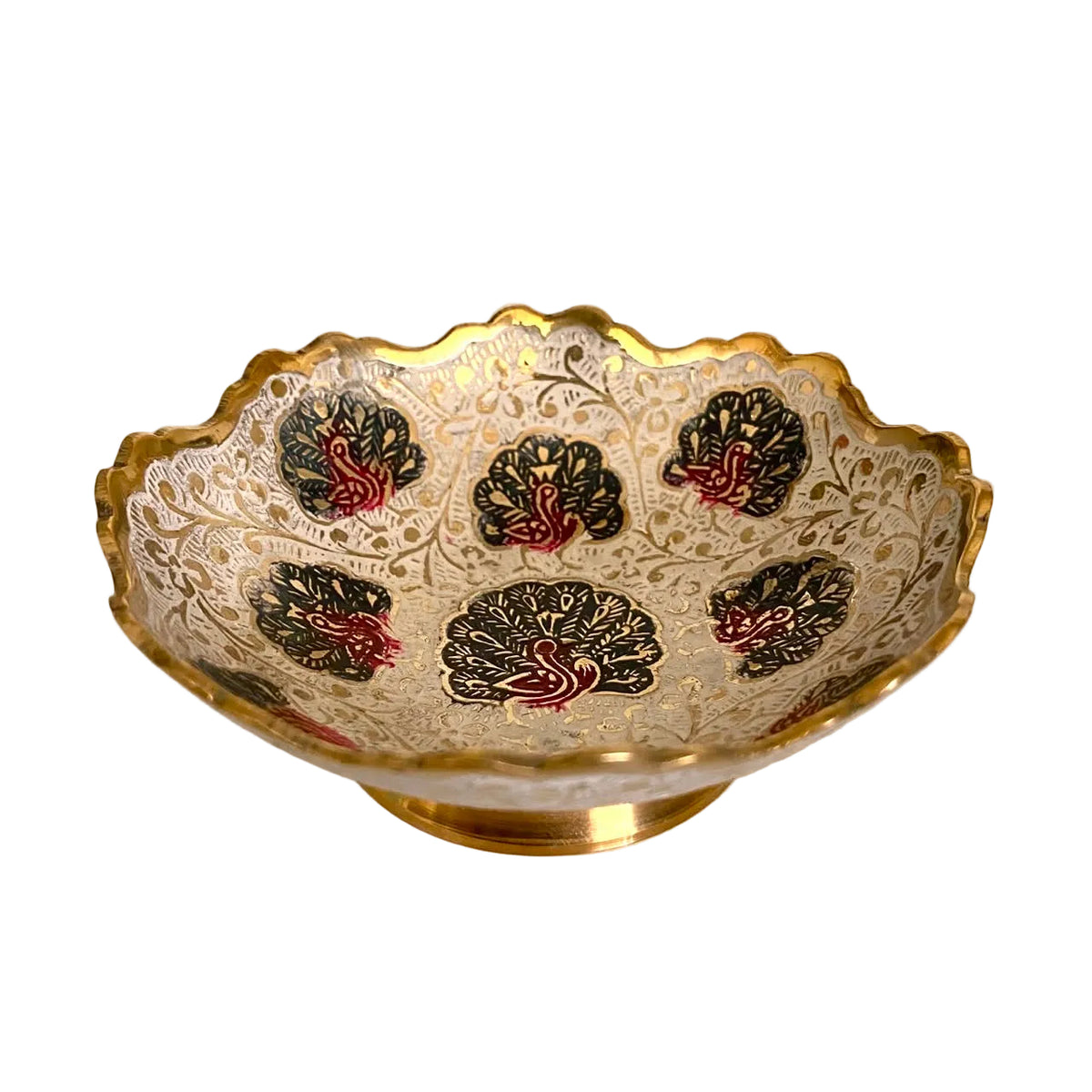 A scalloped glass bowl with a gold base and rim, decorated with intricate gold filigree patterns and five black floral medallions accented with red and gold details, set on a light-colored surface.