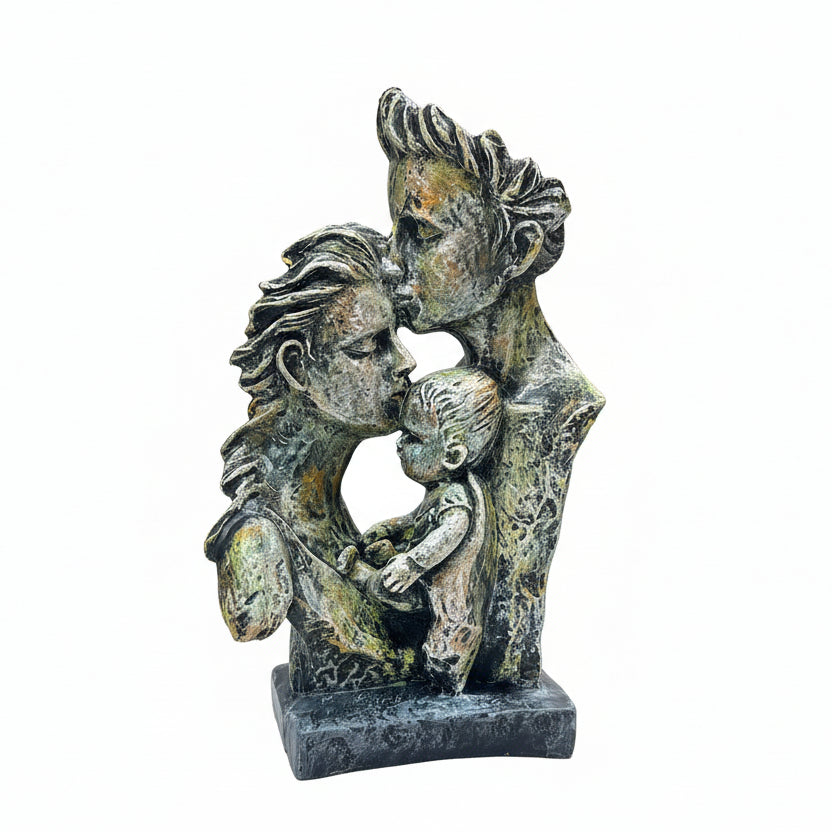 Decorative sculpture of three figures on a marble base held by a hand, with a blurred indoor background.