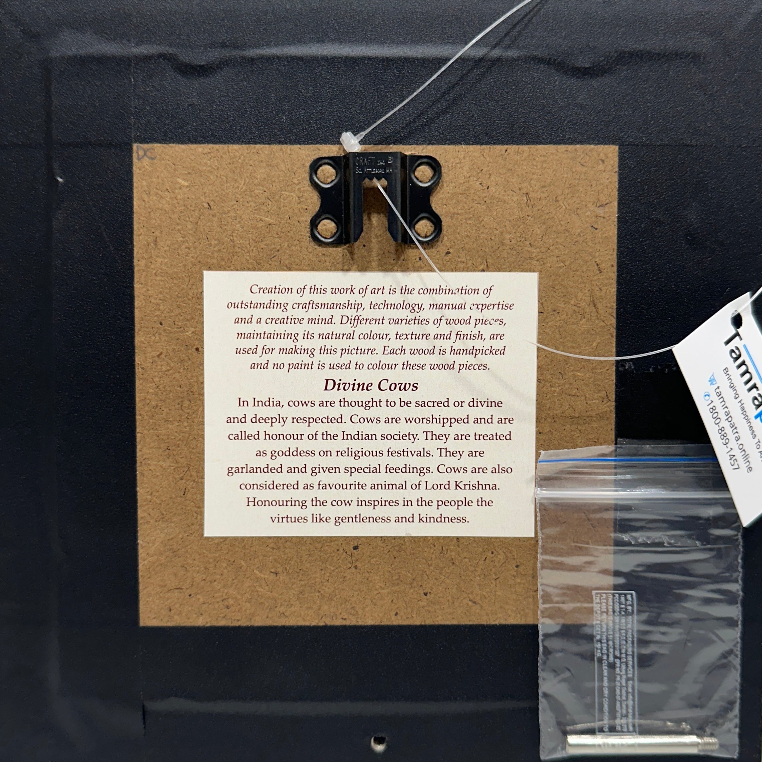 Framed artwork with a text panel and a tag on a white background