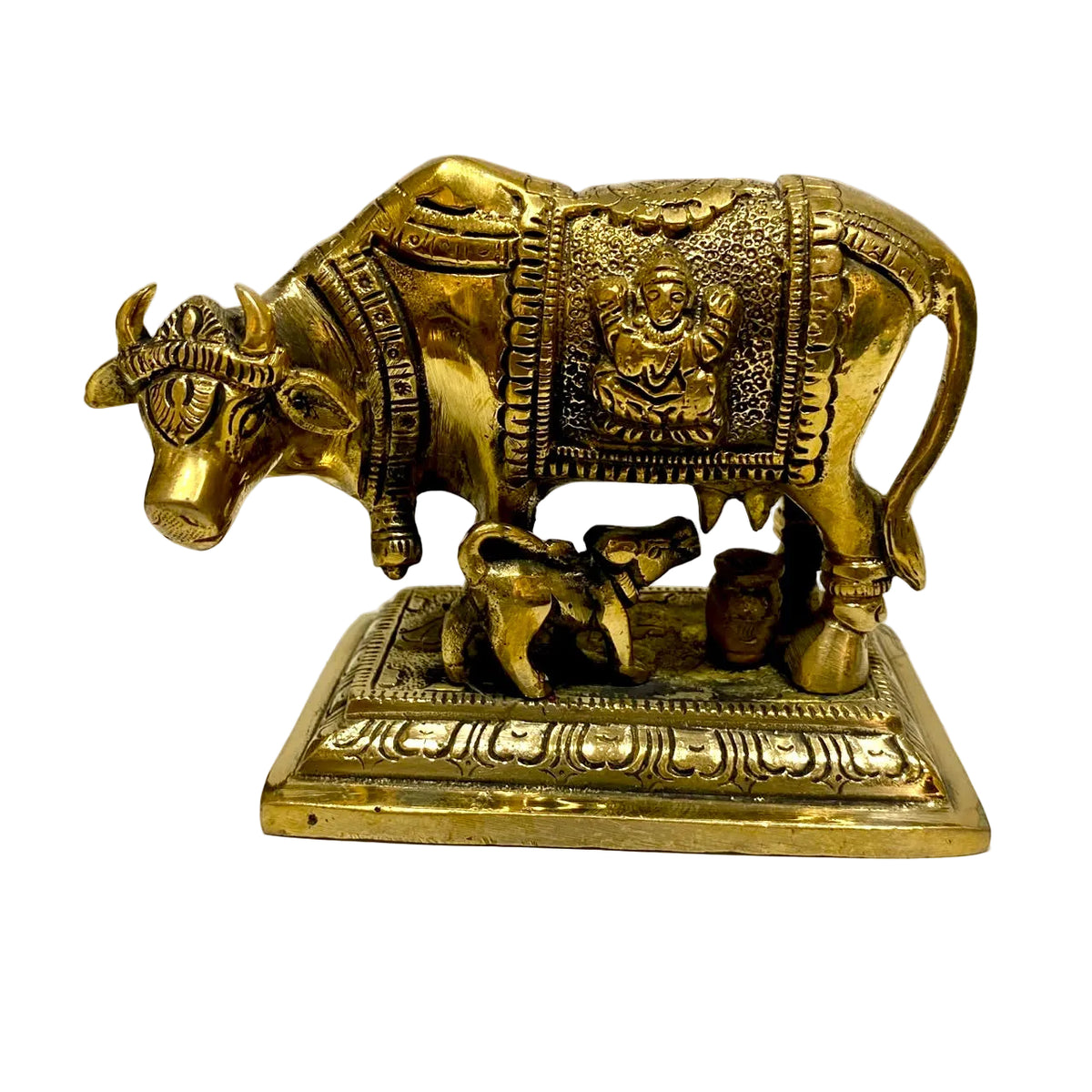 A brass cow and calf figurine with decorative details, standing on a rectangular base against a plain white background.