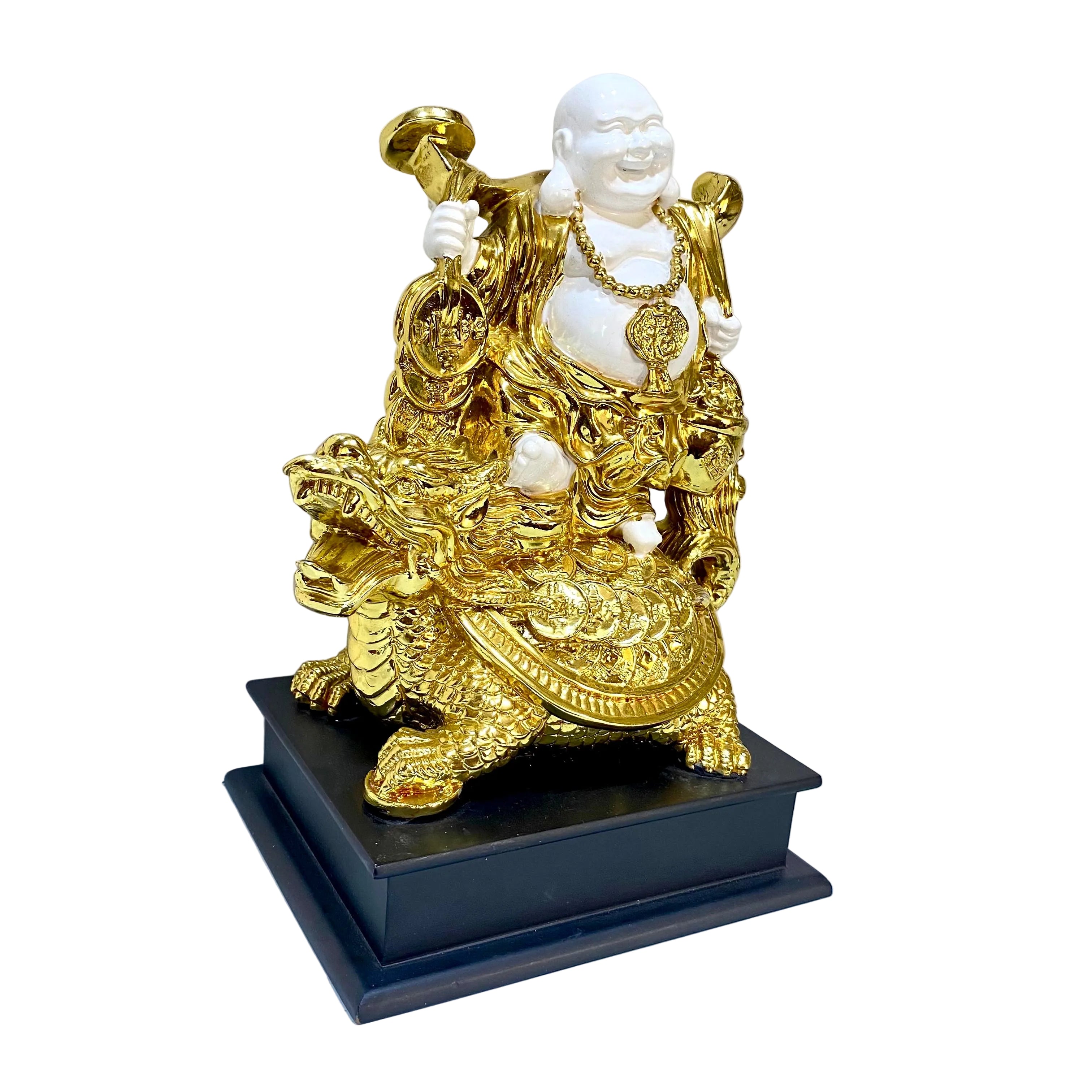 Gold and white statue on a black base against a white wall with a piece of paper.