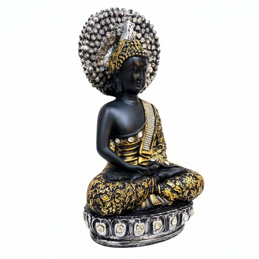 Decorative statue of a seated figure with intricate detailing on a white surface.