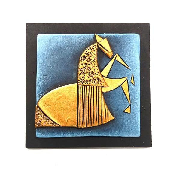 Decorative wall art with a gold and blue design on a white background