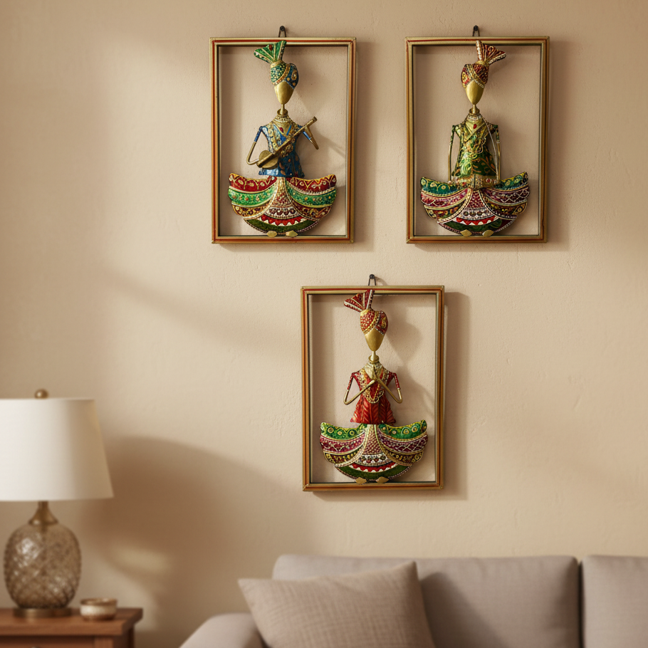 Three decorative wall art pieces of traditional figures on a beige wall above a sofa.