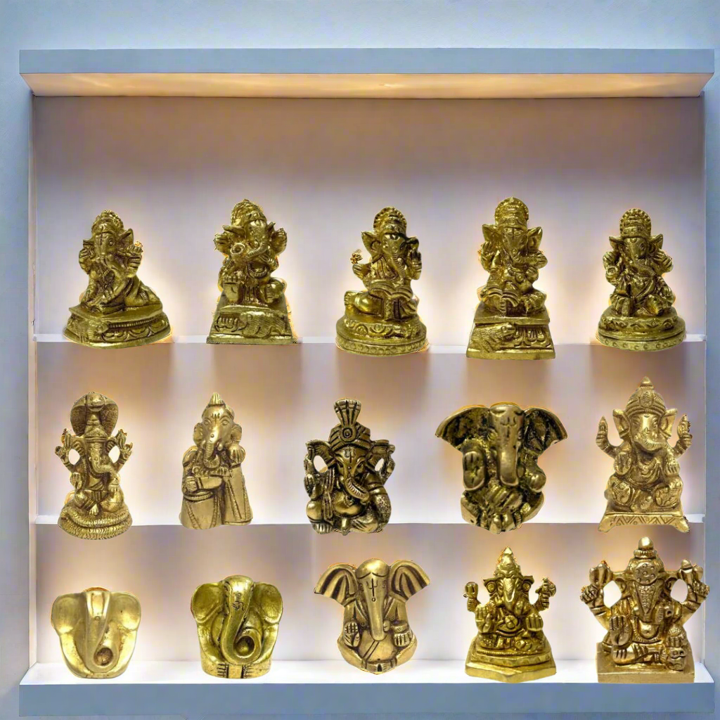 Collection of gold-colored Ganesha statues on a white background