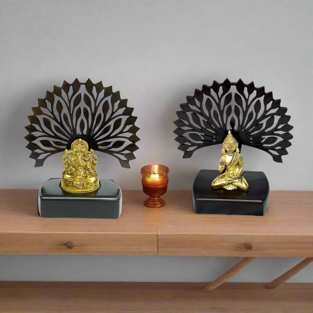Two decorative items with gold figures on black bases and intricate black designs above.