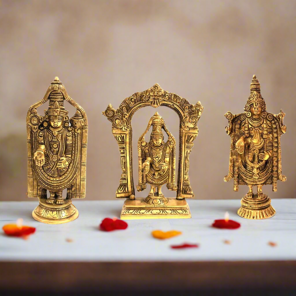 Set of three gold-colored statues on a white background