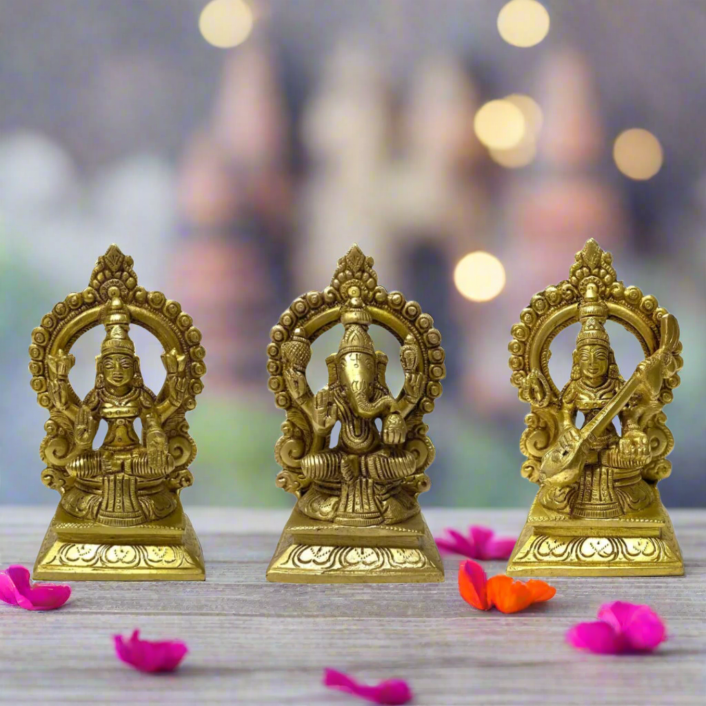 Three gold-colored statues on a white background