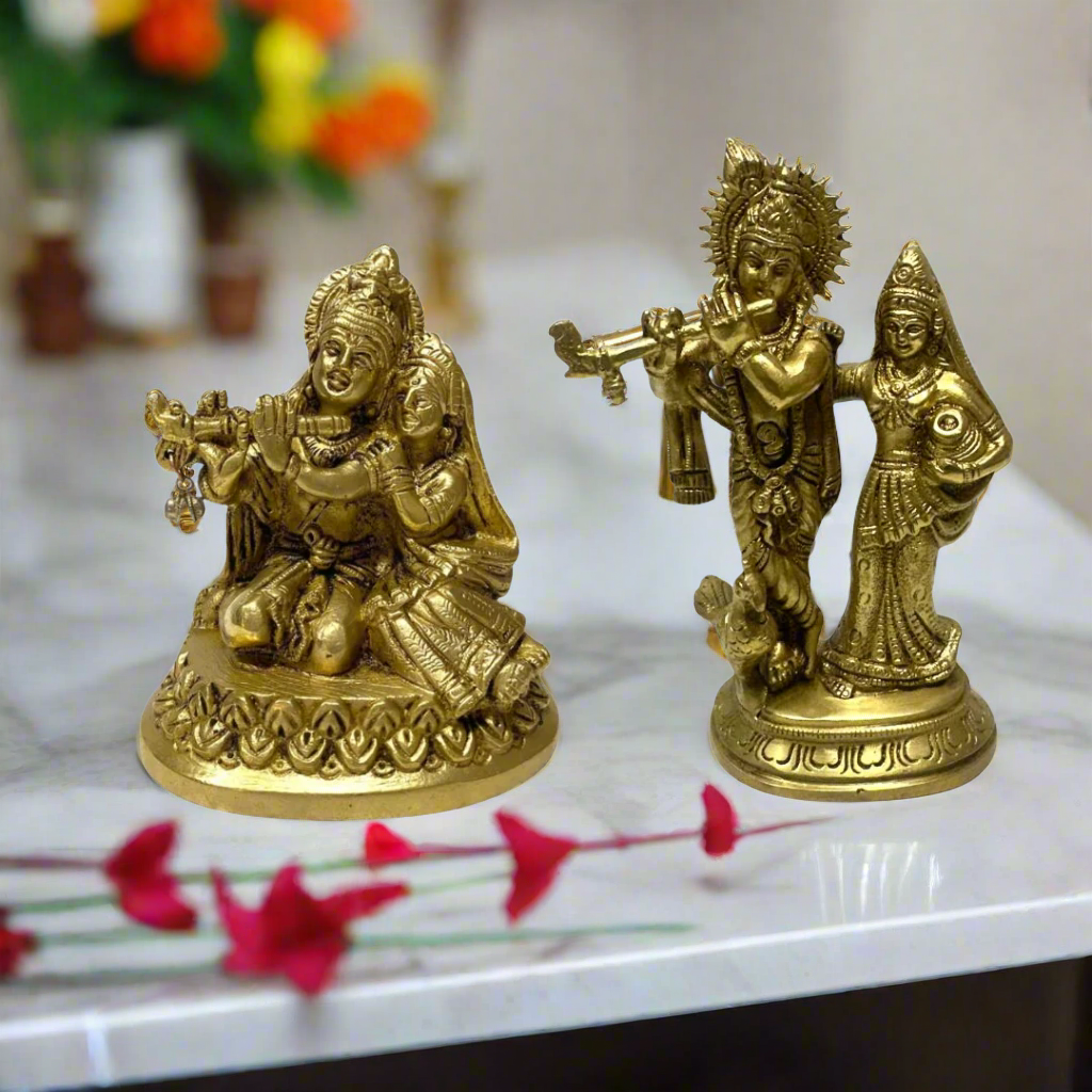 Two gold-colored statues of a couple with musical instruments on a white background