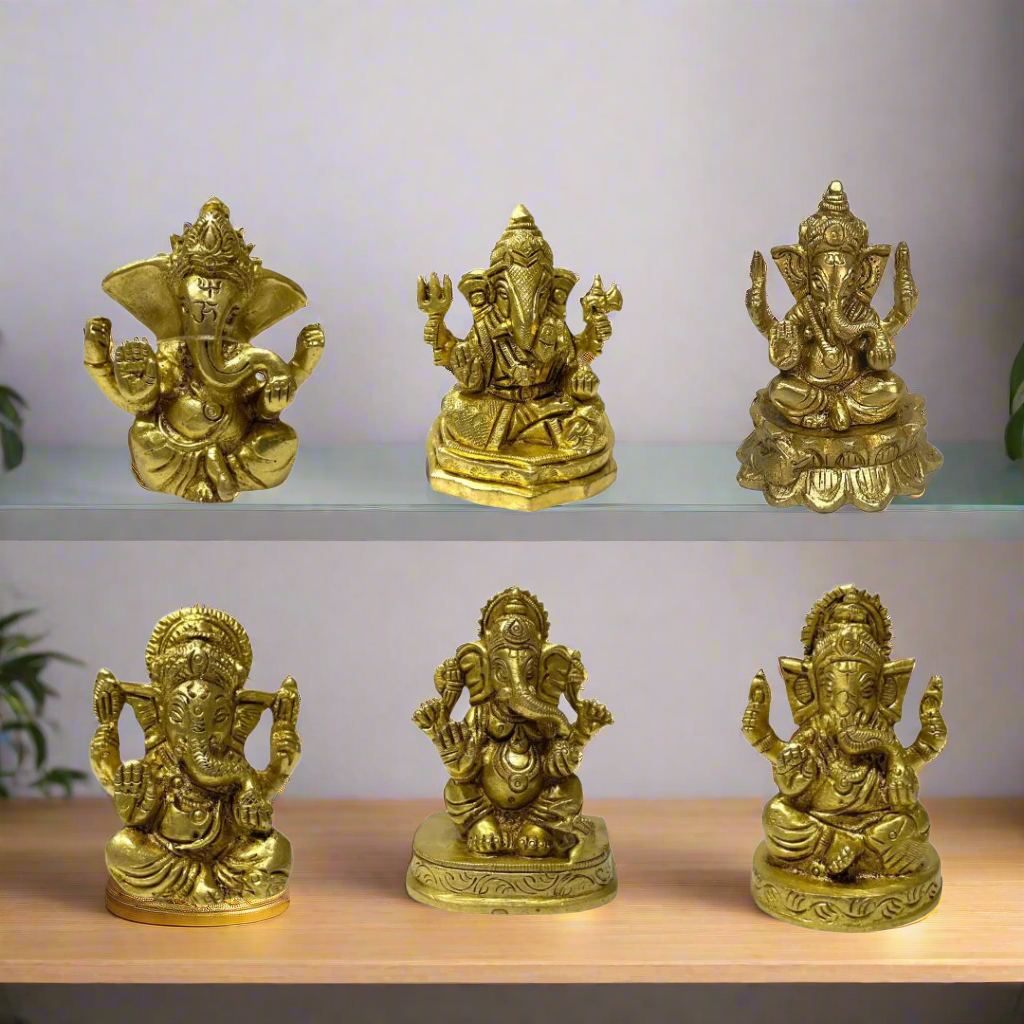 Set of six gold-colored Ganesha statues on a white background