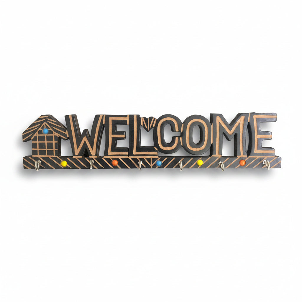 A decorative wooden key holder with the word 'WELCOME' inscribed, featuring a house silhouette on the letter E.