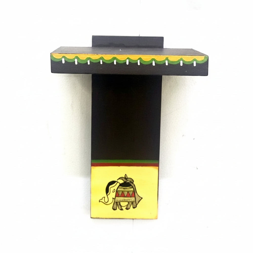 A miniature wooden shelf with an elephant motif in a colorful striped pattern on a black background.